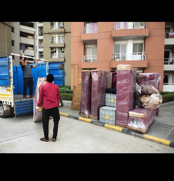 Loading wrapped furniture into truck at apartment